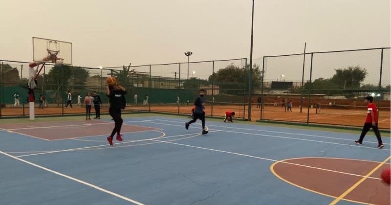 Player shooting a basketball into the hoop in Delhi NCR