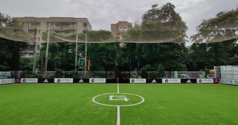 Football match in action on a green field in Delhi NCR