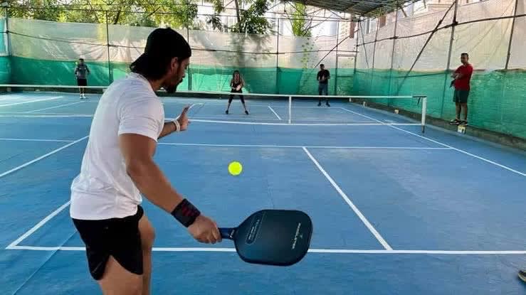 Player serving during a pickleball game in Delhi NCR