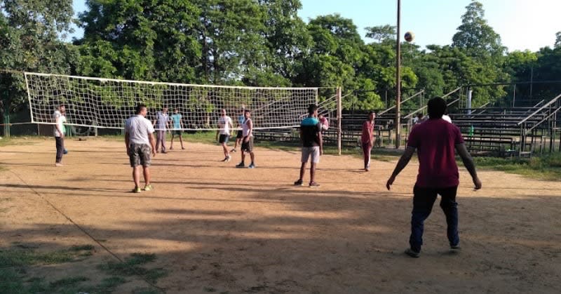 Volleyball players jumping to hit the ball over the net in Delhi NCR